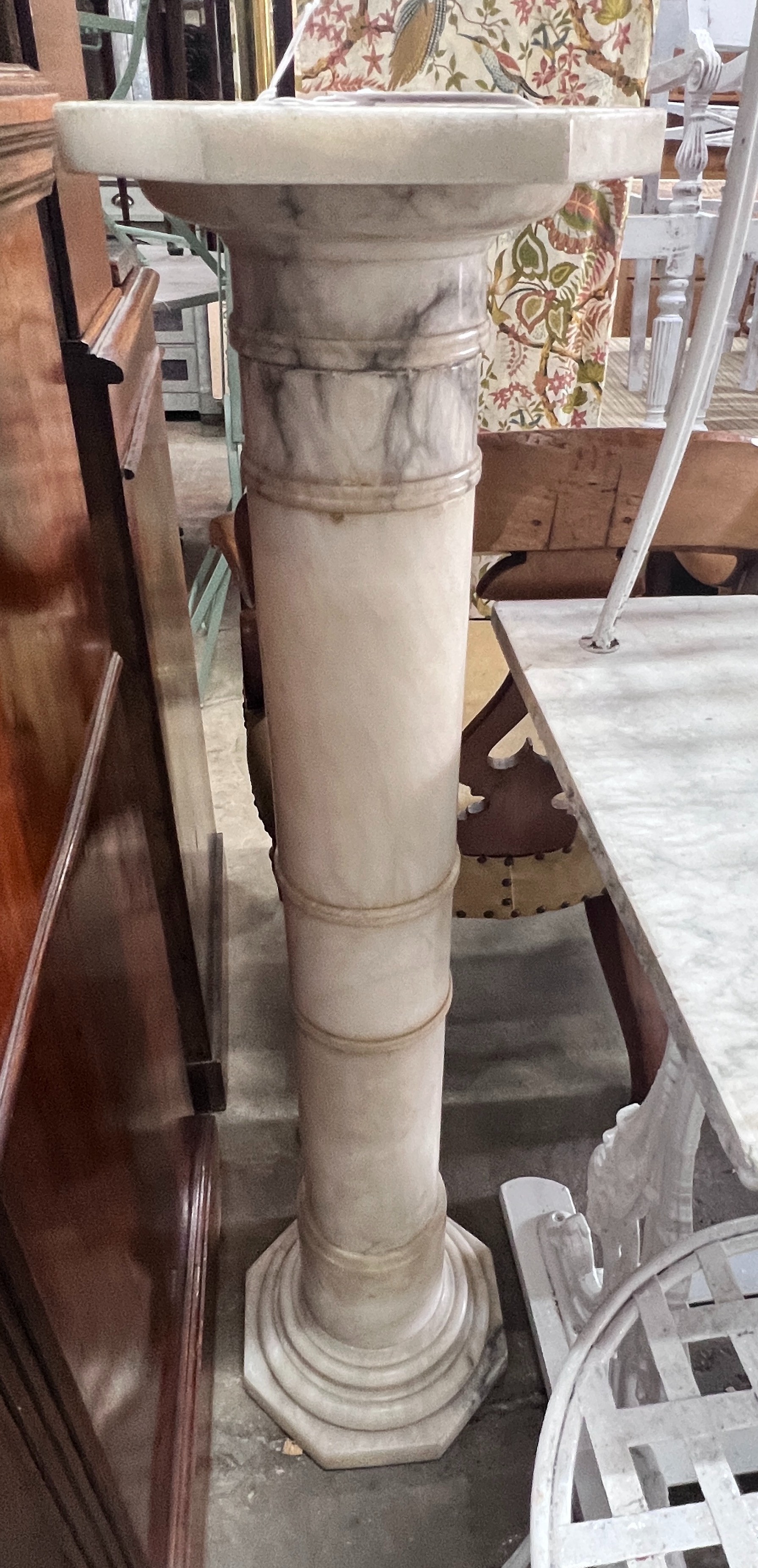 An alabaster sectional pedestal with octagonal top, height 106cm